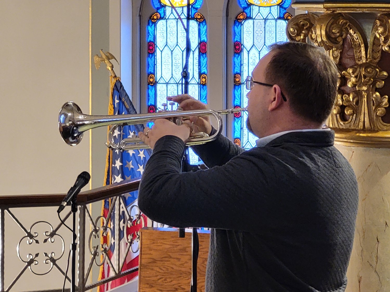 Parish Music Director Nicholas Liese plays “Taps” on a bugle during the Veterans Day Prayer Service on Nov. 11 in St. Peter Church in Jefferson City.